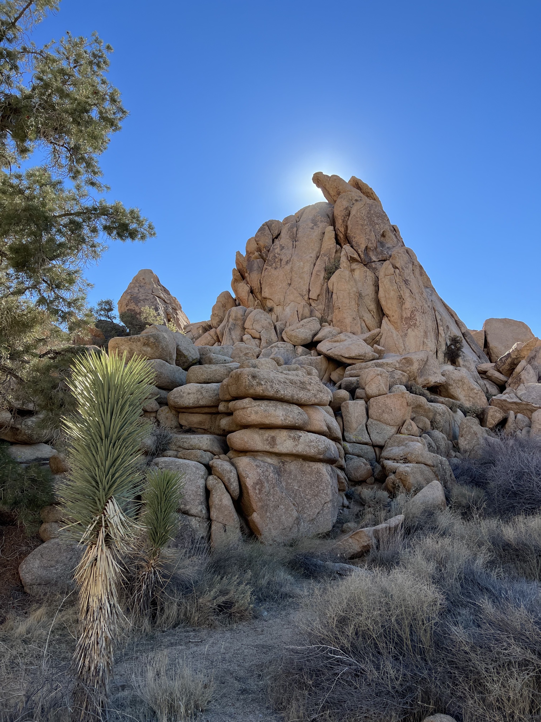 Sun behind rocks
