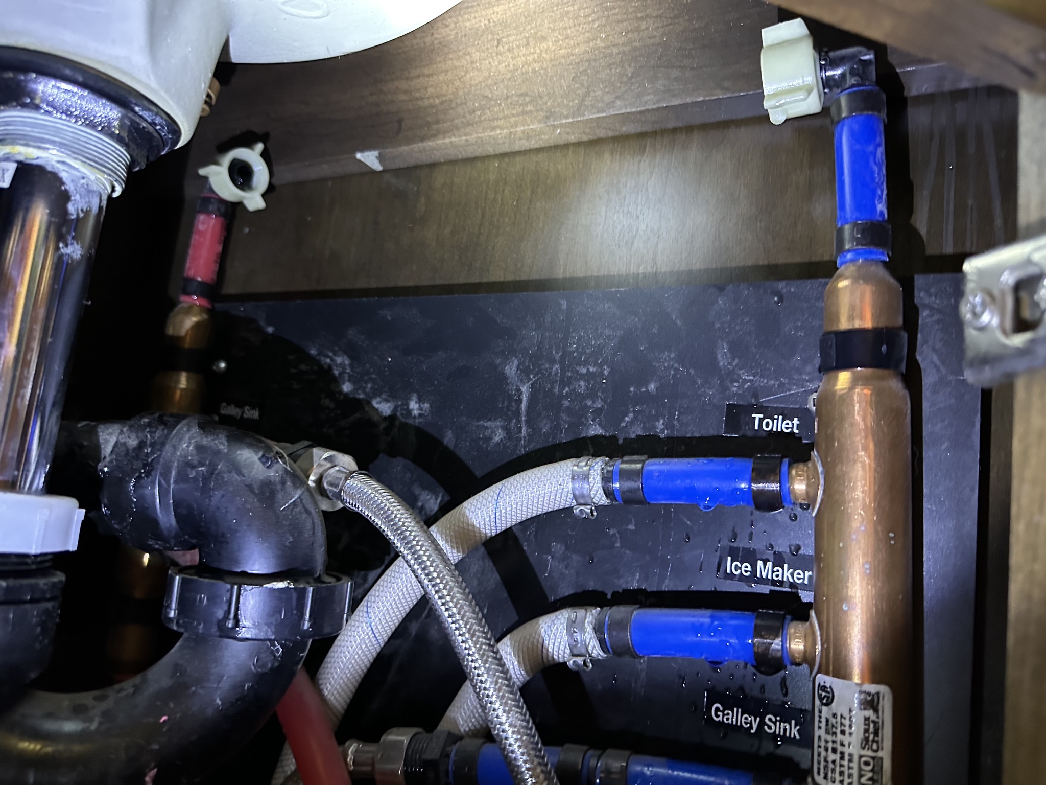 Disconnected hoses under half bath sink
