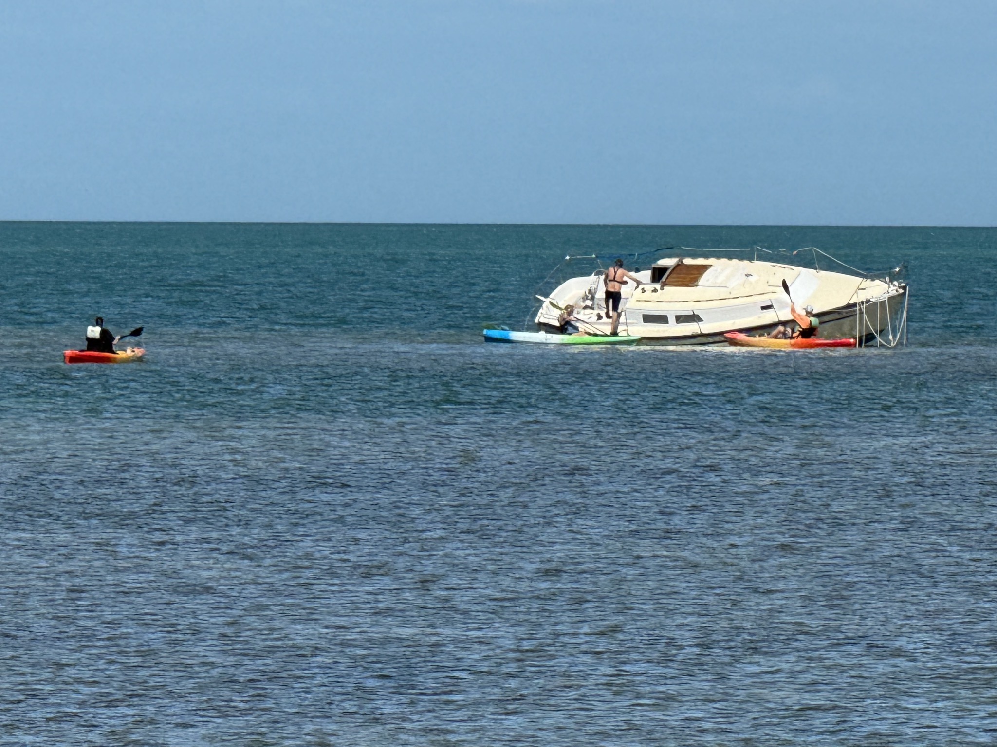 People checking out a grounded boat