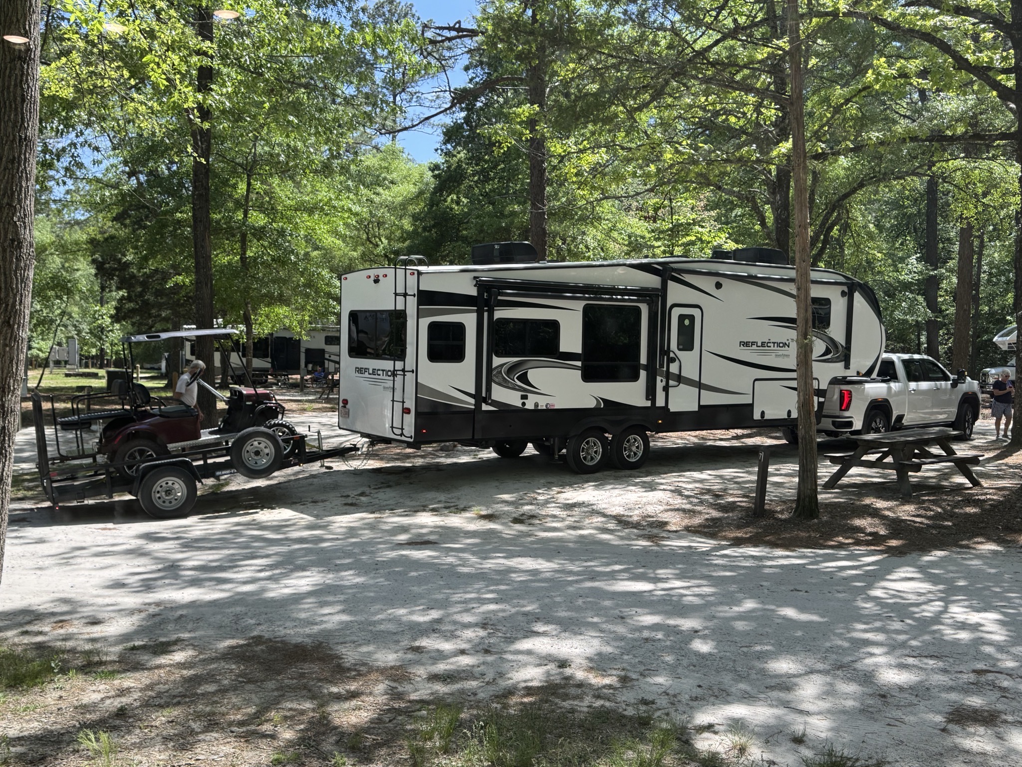 Truck towing fiver towing trailer with golf cart
