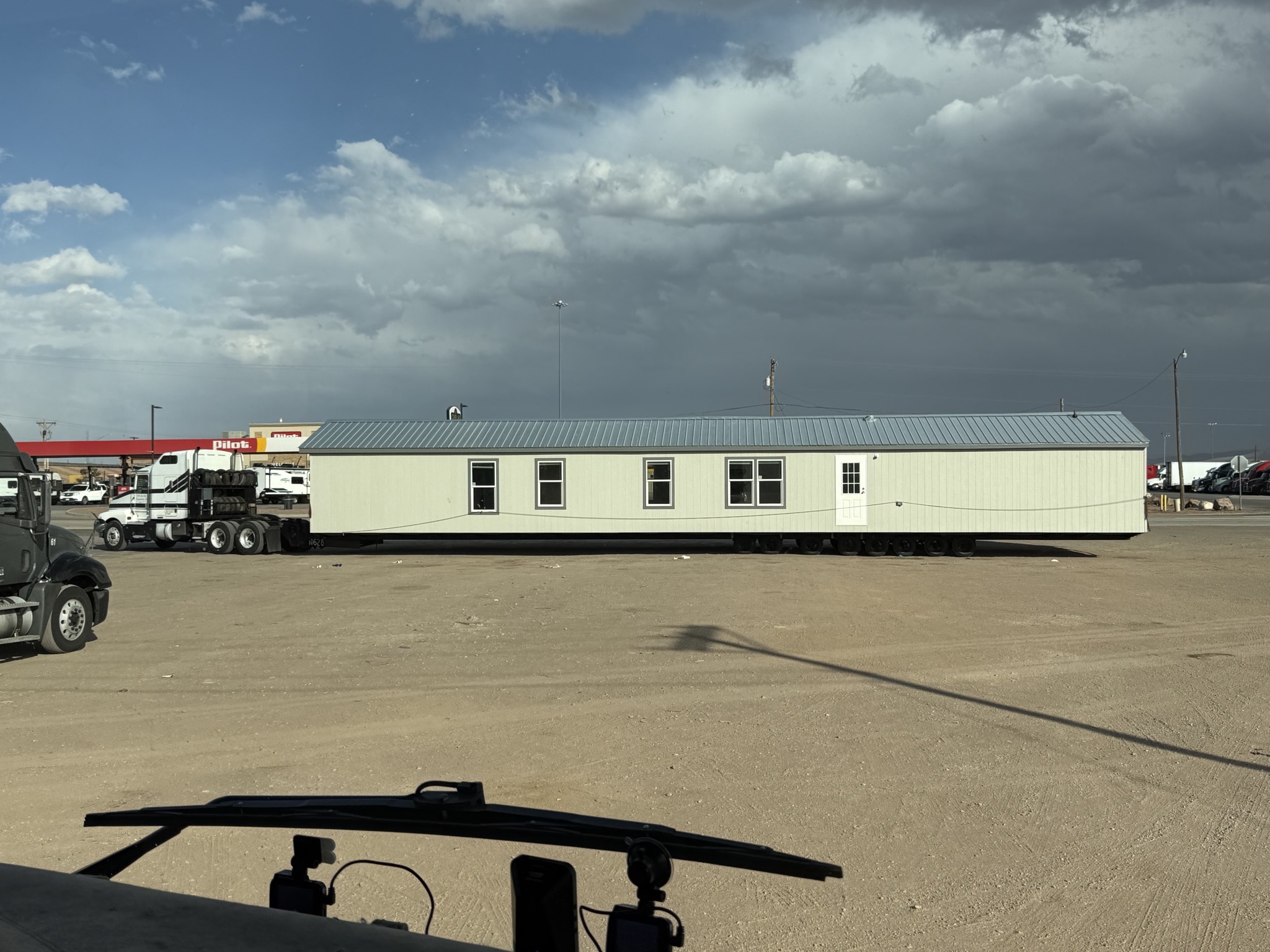A long building on a trailer at stop opportunity
