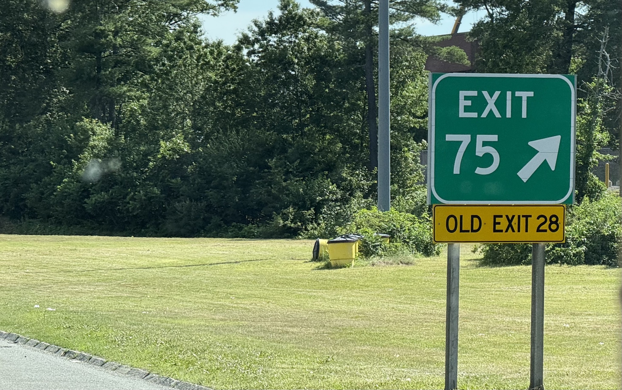 Exit signs are now mile-based, but have old sequential exit numbers too
