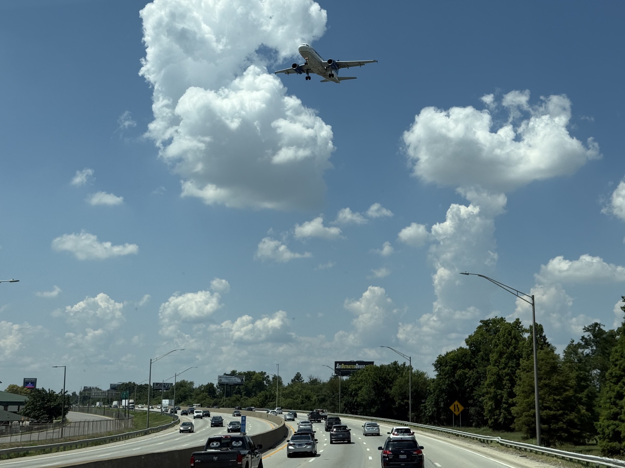 Low plane over freeway, coming in for a landing at the Louisville airport