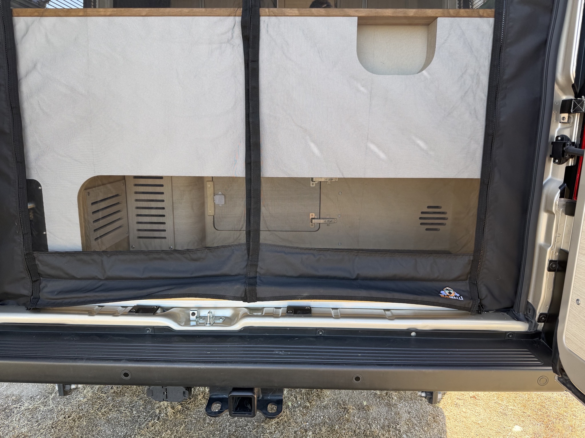 Garage space, covered by bug screen; outdoor shower on left