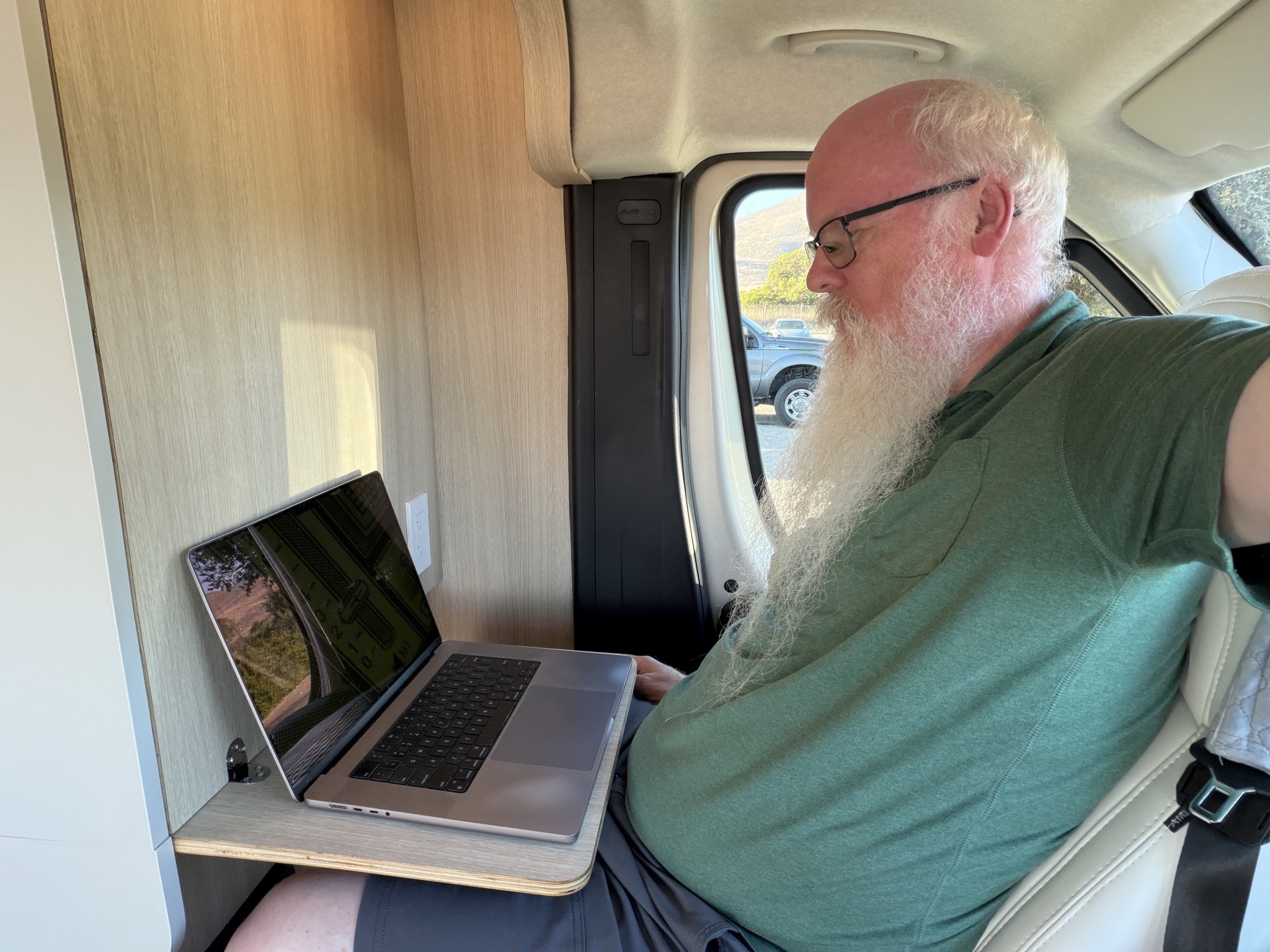 David sitting in driver chair with pull-down desk