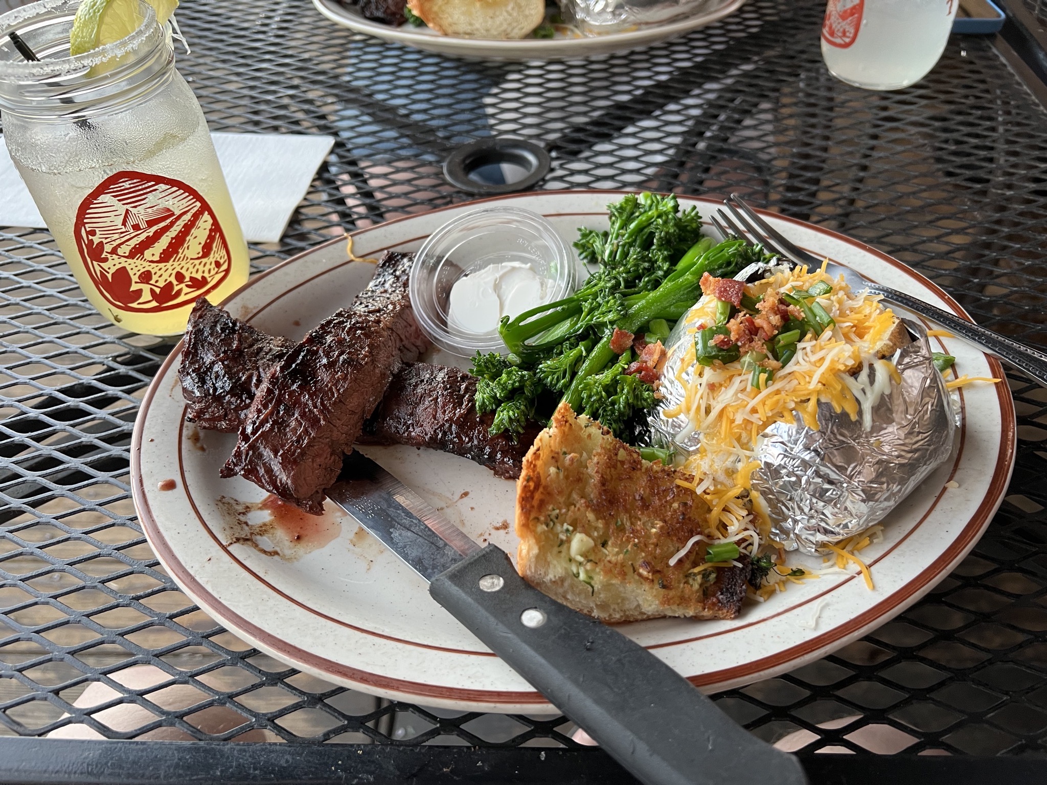 Steak, potato, veggies, garlic bread