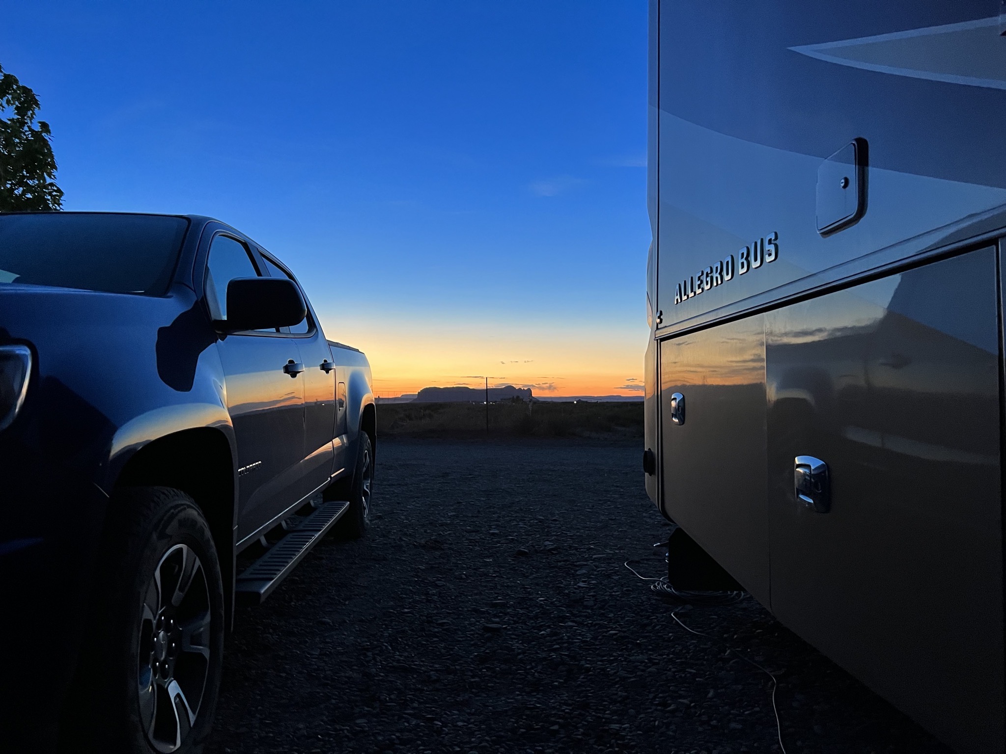 Sunset between truck and coach