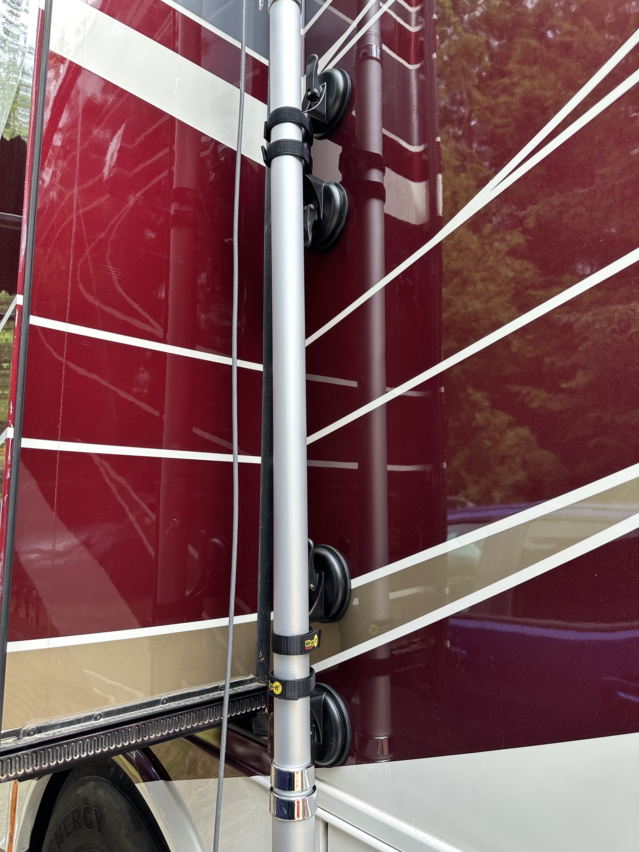 Suction cups and velcro straps holding flag pole