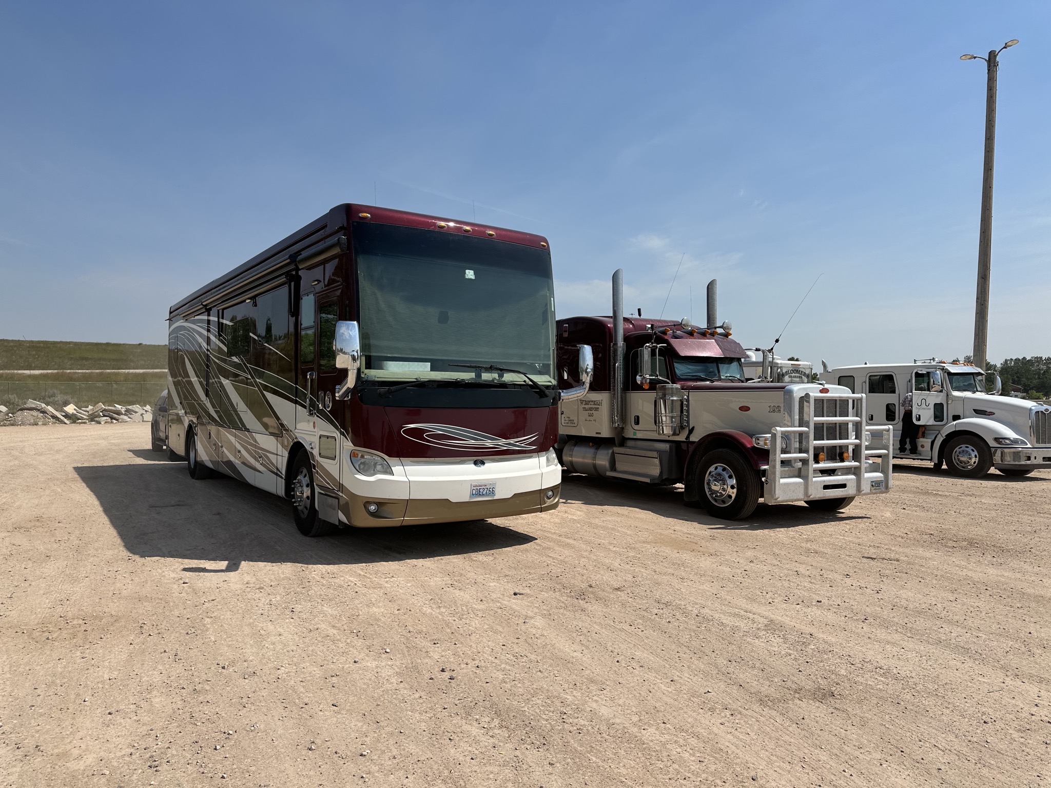 Coach parked with trucks