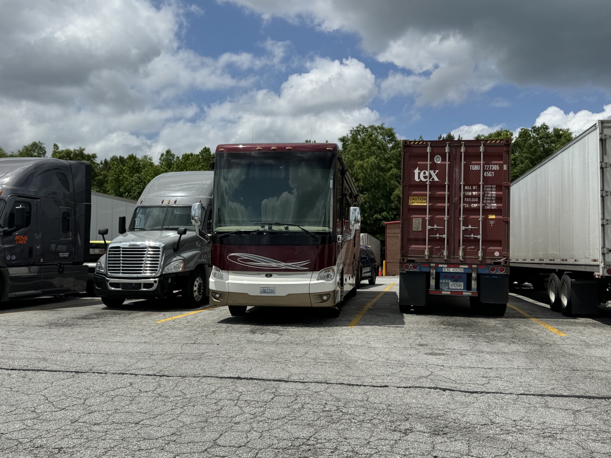 Coach parked with trucks
