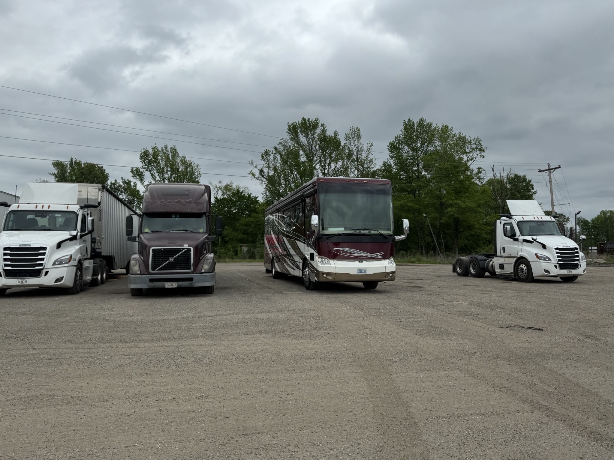 Coach parked with trucks