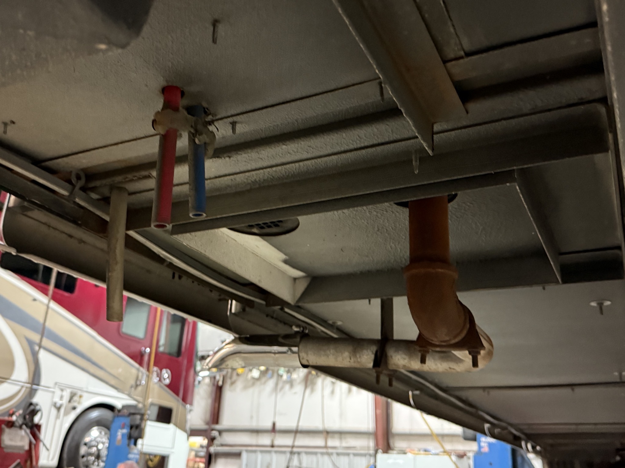 Under wet bay, with hot and cold low point drains, Aqua-Hot coolant overflow, and Aqua-Hot exhaust