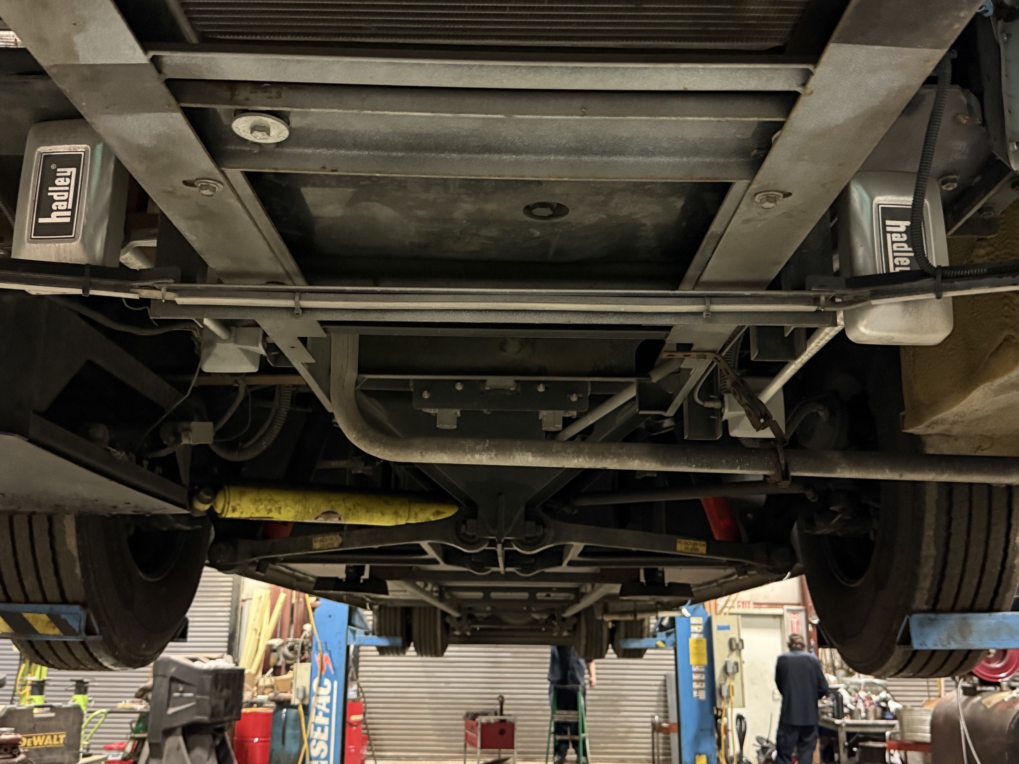 Behind the front wheels, with air horns and generator exhaust