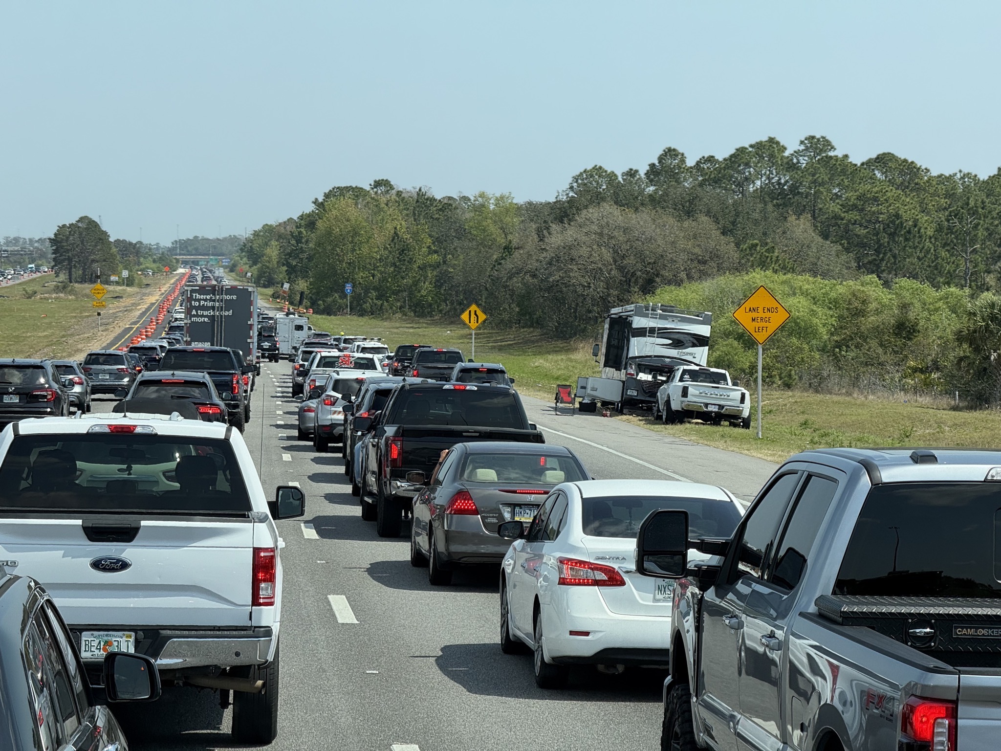 Heavy traffic and RV on the side of the freeway