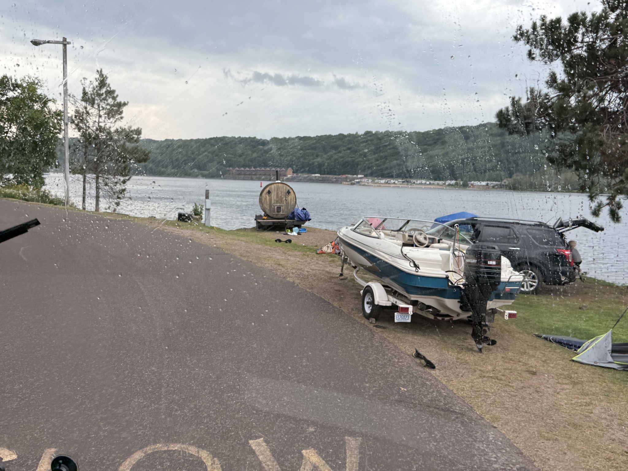 Campsite with tents, boat, and portable sauna